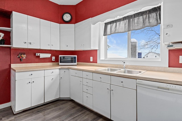 kitchen featuring open shelves, light countertops, a sink, and white appliances
