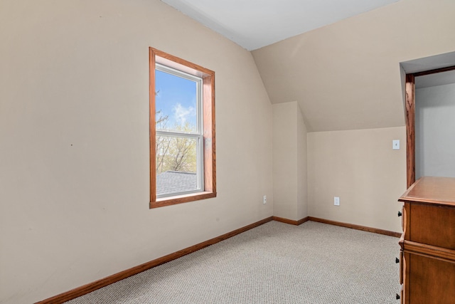 additional living space with carpet, vaulted ceiling, and baseboards