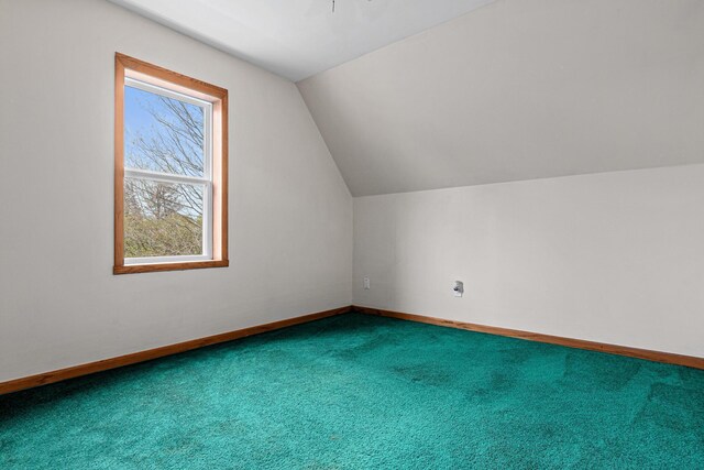 bonus room with baseboards, carpet floors, and vaulted ceiling