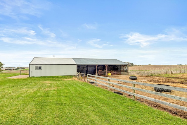 view of stable with a rural view