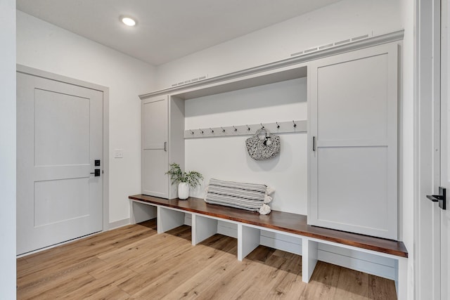 mudroom featuring light wood-style flooring and recessed lighting