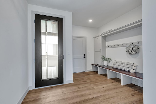 mudroom featuring light wood-type flooring, recessed lighting, and baseboards