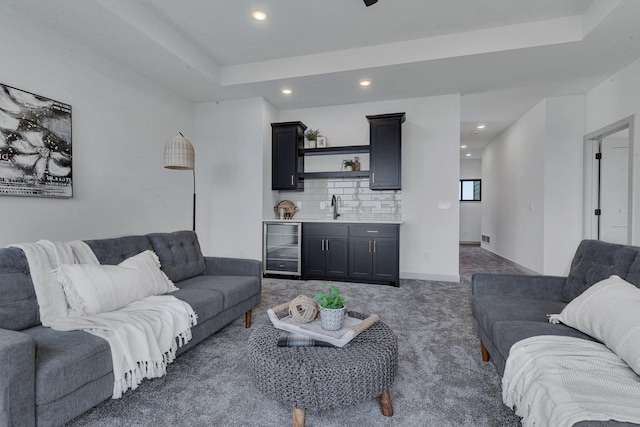living room with wet bar, beverage cooler, carpet flooring, recessed lighting, and a raised ceiling