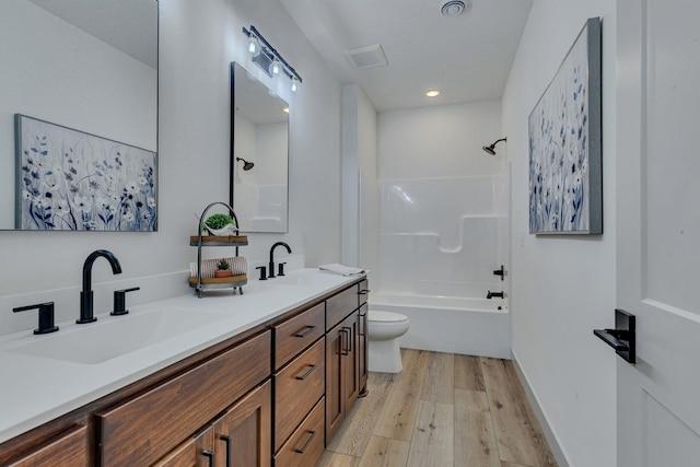 full bathroom featuring wood finished floors, toilet, shower / bath combination, double vanity, and recessed lighting