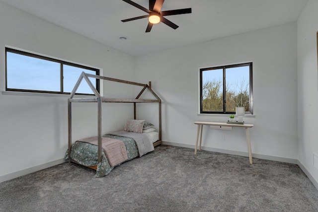 bedroom featuring multiple windows, carpet floors, and baseboards
