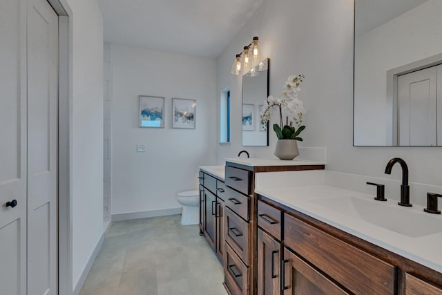 full bathroom featuring toilet, vanity, and baseboards