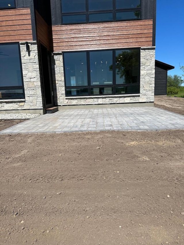 property entrance with stone siding
