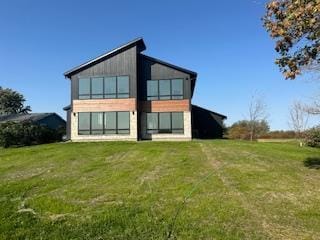 back of property featuring a lawn