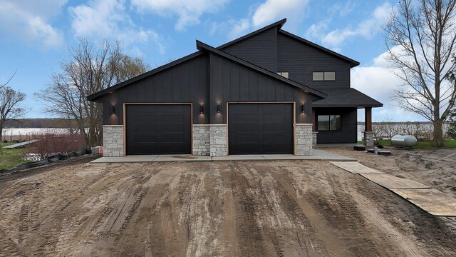 21070 Eagle Dr, Osakis, MN 56360 - view of front of home featuring driveway, stone siding, a garage, and board and batten siding