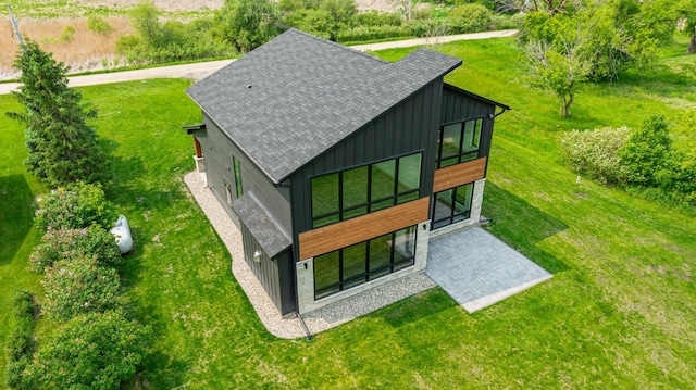 21070 Eagle Dr, Osakis, MN 56360 - back of property featuring board and batten siding, roof with shingles, and a yard