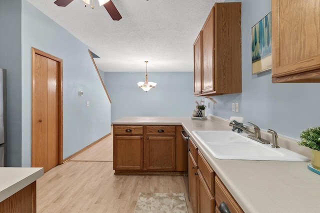 1226 Crystal Pl E, Chaska, MN 55318 - kitchen featuring a sink, light wood finished floors, a peninsula, brown cabinetry, and light countertops