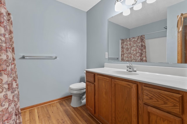 1226 Crystal Pl E, Chaska, MN 55318 - full bathroom with toilet, vanity, wood finished floors, baseboards, and curtained shower