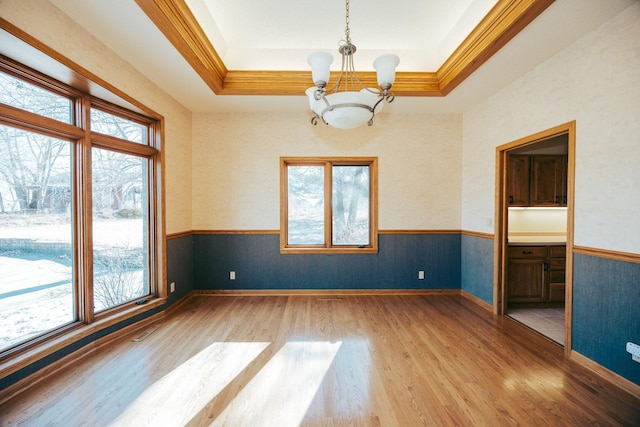 15671 Wermager Beach Rd, Lake Park, MN 56554 - unfurnished room with a chandelier, plenty of natural light, light wood-type flooring, ornamental molding, and wainscoting