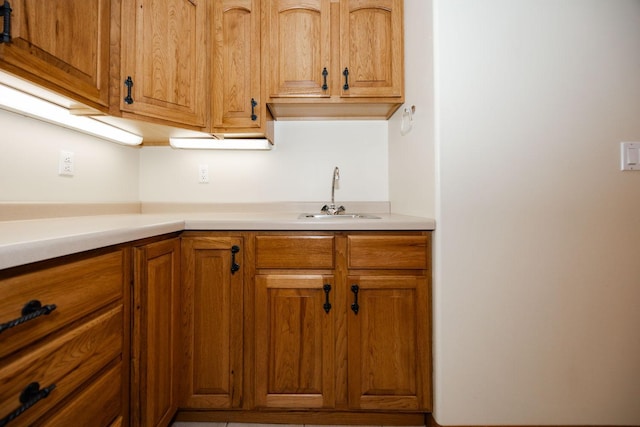 15671 Wermager Beach Rd, Lake Park, MN 56554 - kitchen with a sink, light countertops, and brown cabinetry