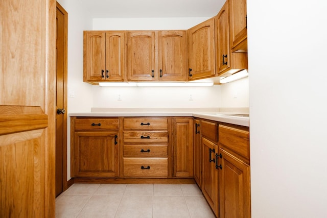 15671 Wermager Beach Rd, Lake Park, MN 56554 - kitchen featuring brown cabinets, light countertops, and light tile patterned floors