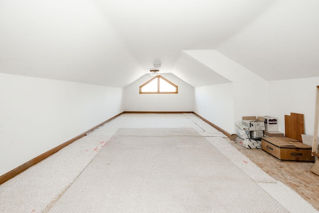15671 Wermager Beach Rd, Lake Park, MN 56554 - bonus room featuring lofted ceiling, baseboards, and light carpet