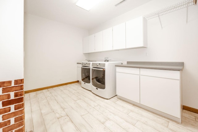 15671 Wermager Beach Rd, Lake Park, MN 56554 - laundry area with separate washer and dryer, cabinet space, baseboards, and light wood-style floors