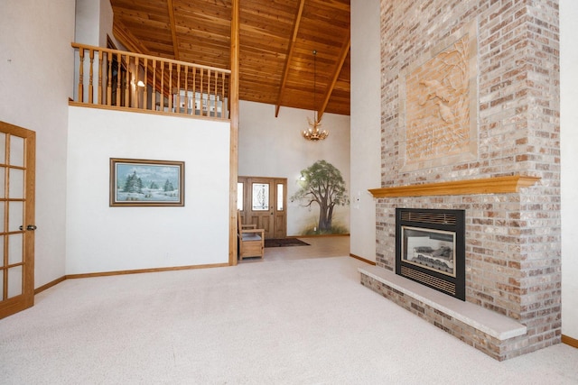 15671 Wermager Beach Rd, Lake Park, MN 56554 - unfurnished living room featuring wood ceiling with exposed beams, high vaulted ceiling, carpet floors, a brick fireplace, and baseboards