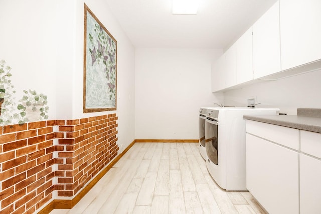 15671 Wermager Beach Rd, Lake Park, MN 56554 - washroom featuring light wood finished floors, cabinet space, baseboards, and washing machine and dryer