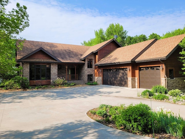 15671 Wermager Beach Rd, Lake Park, MN 56554 - view of front of home featuring concrete driveway, an attached garage, roof with shingles, brick siding, and covered porch