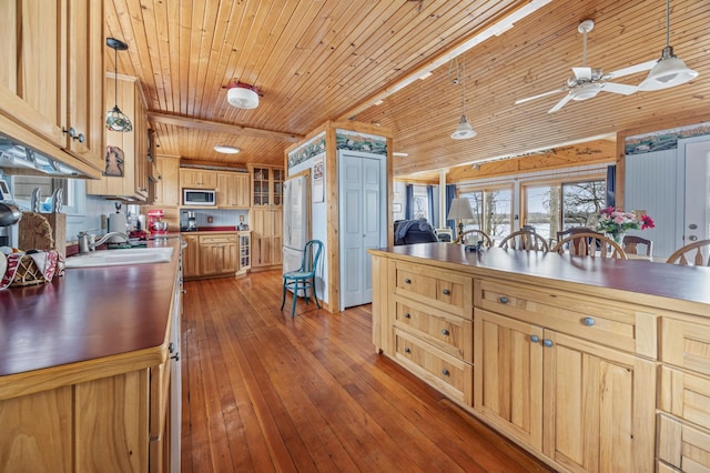 32331 Loon Dr, Candor Twp, MN 56587 - kitchen with stainless steel microwave, wood ceiling, a sink, dark wood finished floors, and pendant lighting