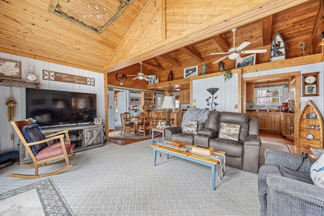 32331 Loon Dr, Candor Twp, MN 56587 - living room featuring wood ceiling, a ceiling fan, wood walls, high vaulted ceiling, and carpet