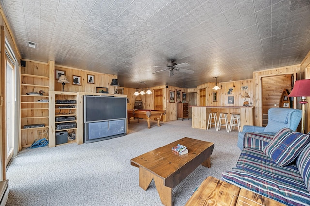 32331 Loon Dr, Candor Twp, MN 56587 - carpeted living area featuring wood walls, billiards, and a ceiling fan