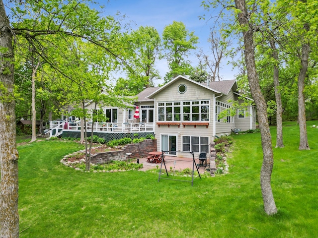 32331 Loon Dr, Candor Twp, MN 56587 - back of house featuring a patio area, a deck, and a lawn