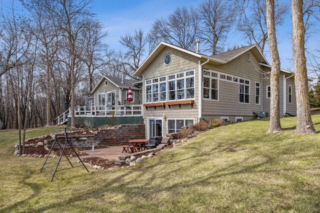 32331 Loon Dr, Candor Twp, MN 56587 - rear view of house featuring a deck, a yard, a patio, and roof with shingles