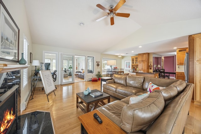 5427 Twin Lake Blvd E, Brooklyn Center, MN 55429 - living area featuring a warm lit fireplace, ceiling fan, light wood-style flooring, recessed lighting, and high vaulted ceiling