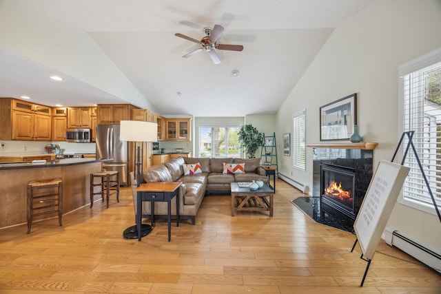 5427 Twin Lake Blvd E, Brooklyn Center, MN 55429 - living room featuring a baseboard heating unit, light wood-style floors, healthy amount of natural light, high vaulted ceiling, and recessed lighting