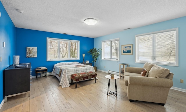 5427 Twin Lake Blvd E, Brooklyn Center, MN 55429 - bedroom featuring a baseboard heating unit, a textured ceiling, wood finished floors, and baseboards