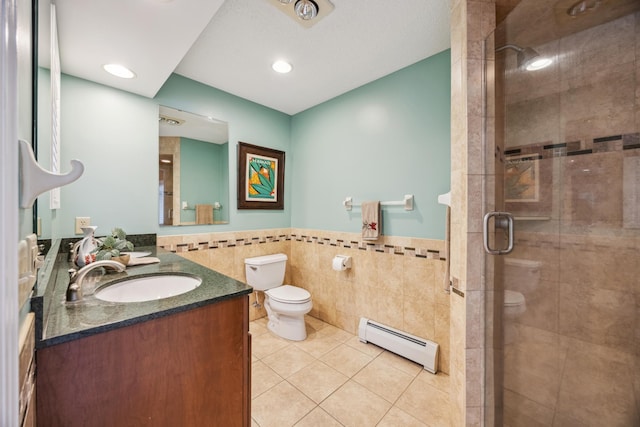 5427 Twin Lake Blvd E, Brooklyn Center, MN 55429 - full bathroom featuring a baseboard radiator, tile walls, toilet, tile patterned floors, and a stall shower