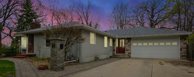 5427 Twin Lake Blvd E, Brooklyn Center, MN 55429 - ranch-style house featuring stucco siding, a chimney, driveway, a garage, and stone siding