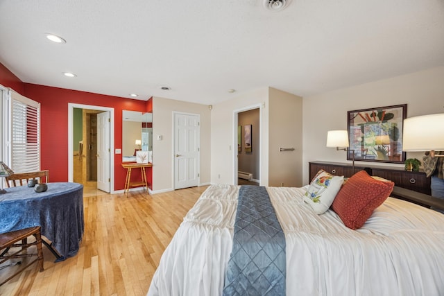 5427 Twin Lake Blvd E, Brooklyn Center, MN 55429 - bedroom with light wood-style floors, recessed lighting, baseboards, and a baseboard heating unit