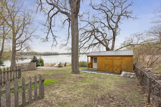 5427 Twin Lake Blvd E, Brooklyn Center, MN 55429 - view of yard with a water view, an outbuilding, a shed, and fence
