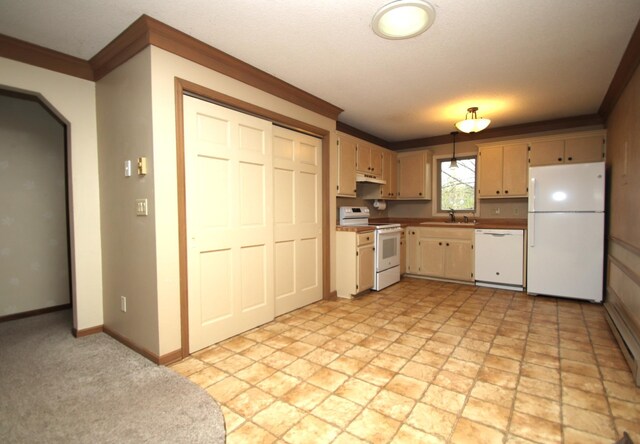 kitchen with ornamental molding, white appliances, baseboards, under cabinet range hood, and a sink