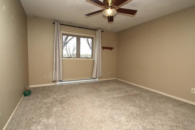 empty room with carpet floors, baseboards, ceiling fan, and a baseboard heating unit