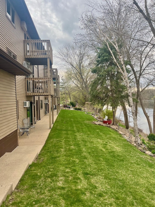 view of yard with a balcony and a patio area