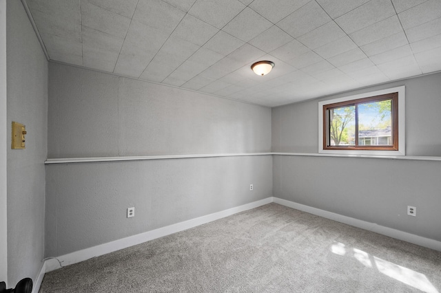 below grade area featuring carpet and baseboards