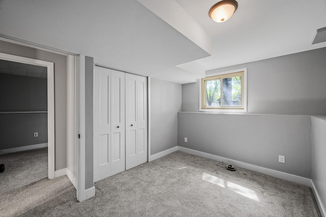 unfurnished bedroom with carpet flooring, a closet, and baseboards
