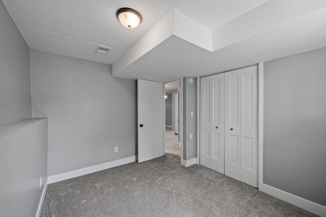 unfurnished bedroom with carpet floors, baseboards, and a closet
