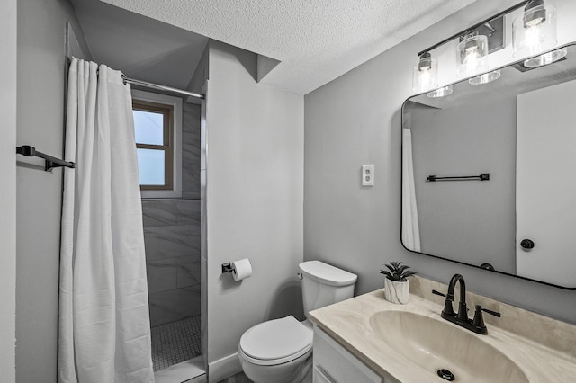 full bath with a stall shower, toilet, a textured ceiling, and vanity