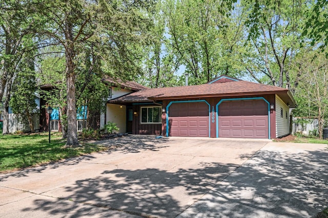 view of front of property featuring an attached garage, concrete driveway, board and batten siding, and a shingled roof