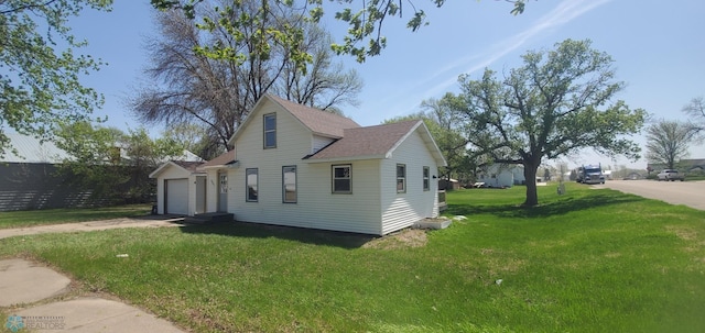 721 Front St, Hawley, MN 56549 - view of home's exterior with a lawn, roof with shingles, driveway, and a garage