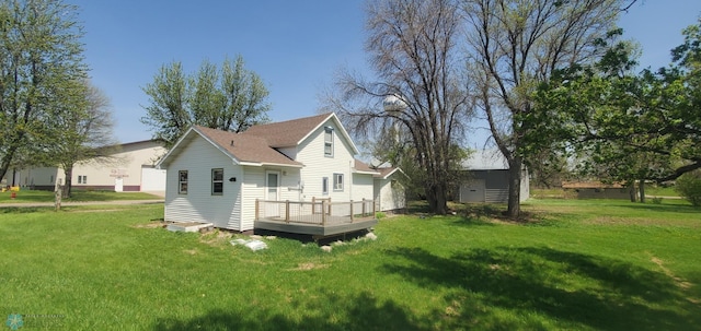 721 Front St, Hawley, MN 56549 - rear view of house featuring a deck and a lawn