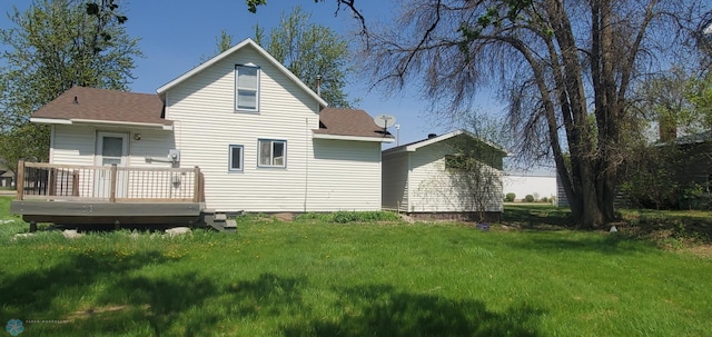 721 Front St, Hawley, MN 56549 - rear view of house featuring a wooden deck, a yard, and a shingled roof
