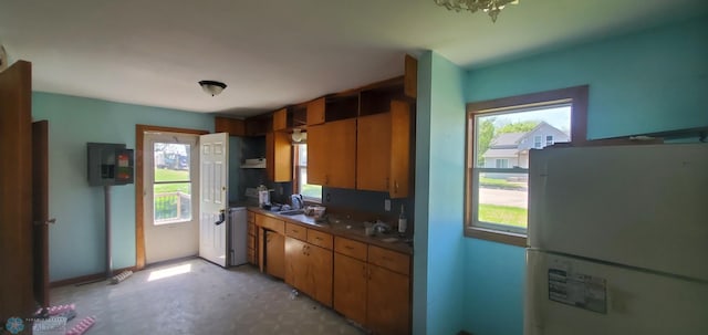 721 Front St, Hawley, MN 56549 - kitchen with freestanding refrigerator, a sink, light flooring, and electric panel