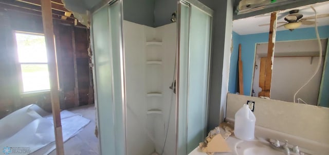 721 Front St, Hawley, MN 56549 - bathroom featuring a stall shower, plenty of natural light, a ceiling fan, and a sink