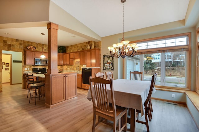 7232 Kestrel Trl, Savage, MN 55378 - dining room with light wood finished floors, a chandelier, high vaulted ceiling, and baseboards